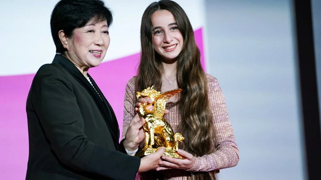 Actress Wardi Eilabouni (R), who starred in 'Palestine 36', receives a trophy from Tokyo Governor Yuriko Koike after the film won the Tokyo International Film Festival’s Governor of Tokyo Award/Tokyo Grand Prix (AFP)