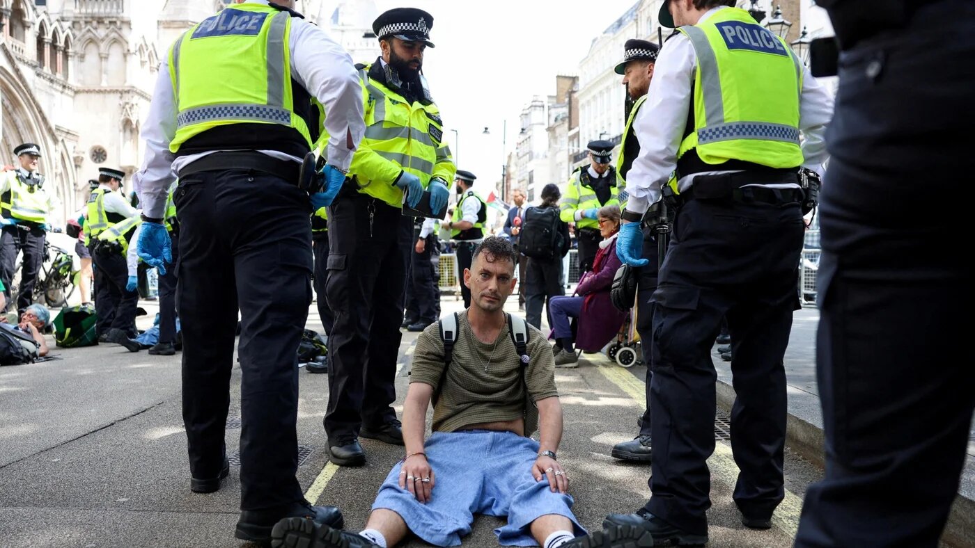Police detain a protester opposing the proscription Palestine Action as a terrorist organisation, following a Court of Appeal ruling, outside the Royal Courts of Justice in London on 15 June 2026 (Corey Rudy/Reuters)