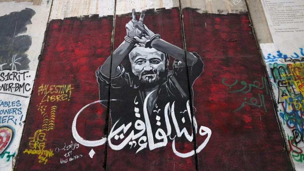 A mural depicts imprisoned Fatah official Marwan Barghouti, on Israel’s separation barrier in Bethlehem, in the occupied West Bank, on 24 December 2024 (Ahmad Gharabli/AFP)