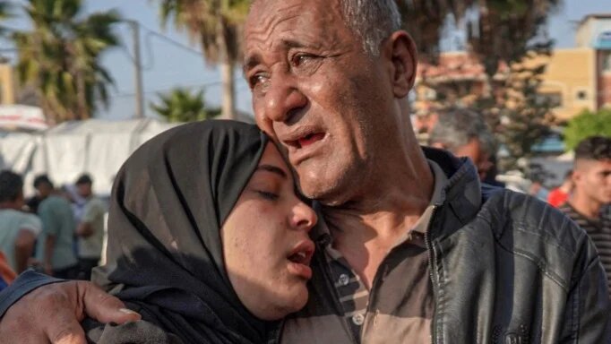 Palestinians mourn the death of loved ones after an Israeli bombardment targeting Gaza’s al-Maghazi refugee camp on 16 April 2024 (AFP)
