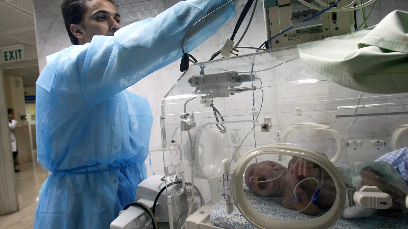 A Palestinian medic fixes the wires of a baby incubator at the al-Makassed in occupied East Jerusalem (AFP/file)