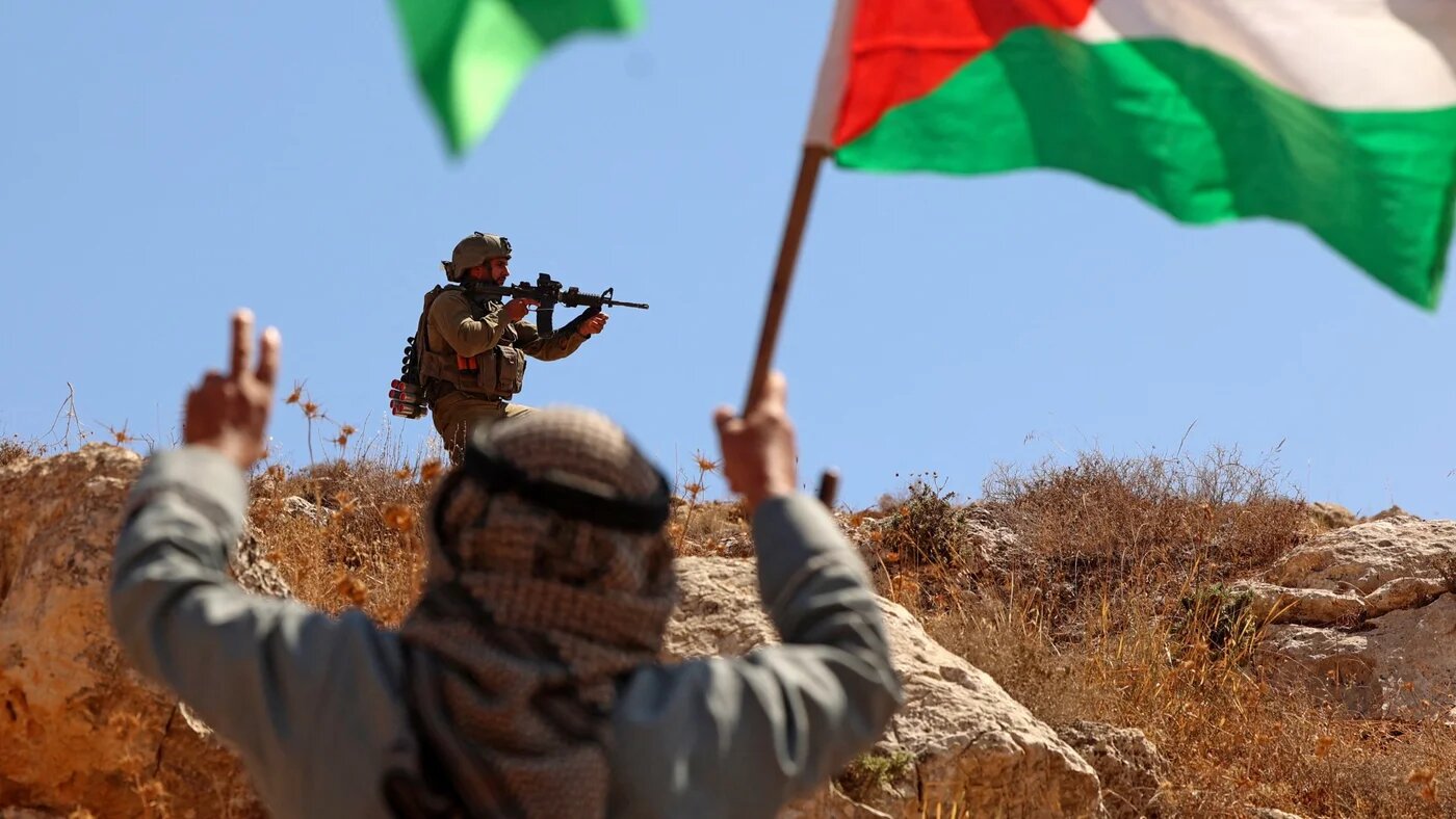 Palestinians demonstrate near Israeli forces against the establishment of Israeli outposts in Beit Dajan, east of Nablus, in the Israeli-occupied West Bank on 9 September 2022 (Jaafar Ashtiyeh/AFP)