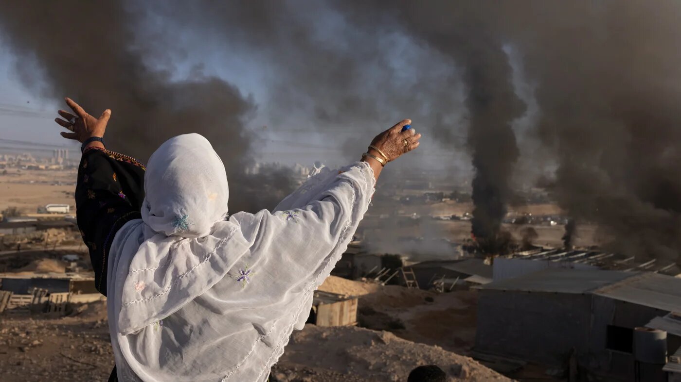 A Palestinian Bedouin woman screams as she watches Israeli police raze her village, al-Sir, in southern Israel, on 17 September 2025 (Oren Ziv/MEE)
