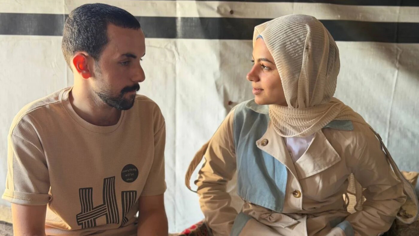 Hamada al-Banna, who was forcibly disappeared for around a year in Israeli detention, sits with is fiancee Reem Jadallah in Gaza City (Hani Abu Rezeq/Middle East Eye)