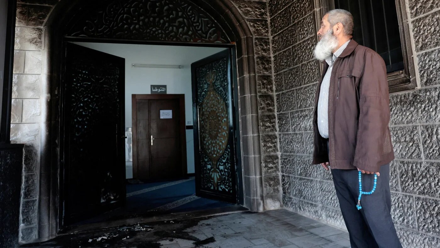 A Palestinian inspects damage to a mosque in Nablus, West Bank, after a settler attack, 23 February, 2026 (Reuters/Mohamad Torokman)