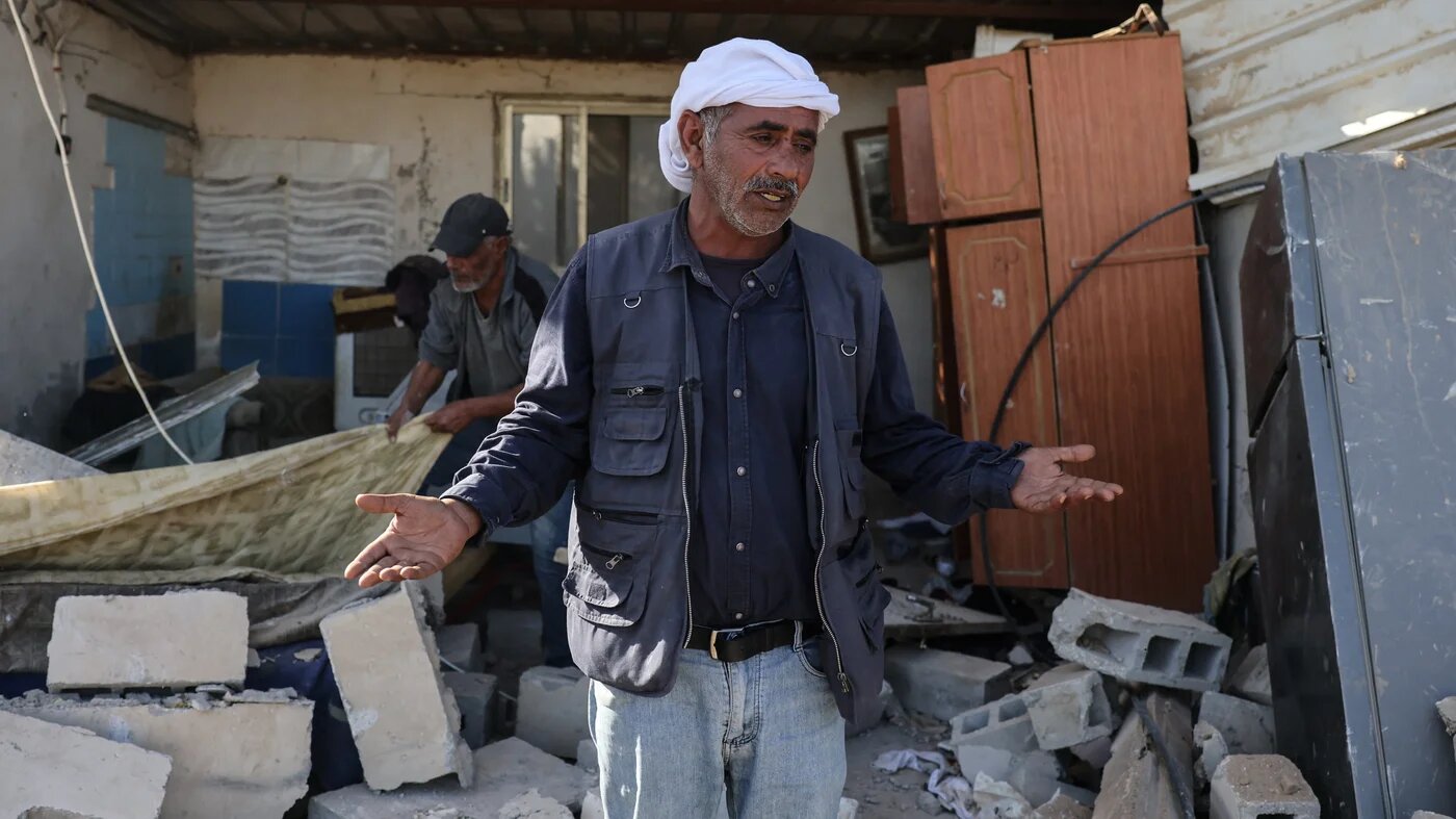 A Palestinian man stands on the rubble of a house demolished by Israeli settlers in Jericho, occupied West Bank, on 11 February 2026 (AFP/Ahmad Gharabli)