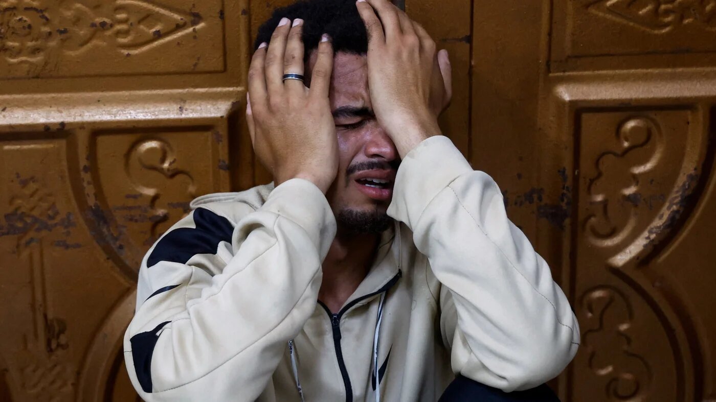 A Palestinian mourns police officers killed in an Israeli strike, in Khan Younis, south Gaza, on 10 May, 2026 (Haseeb Alwazeer/Reuters)
