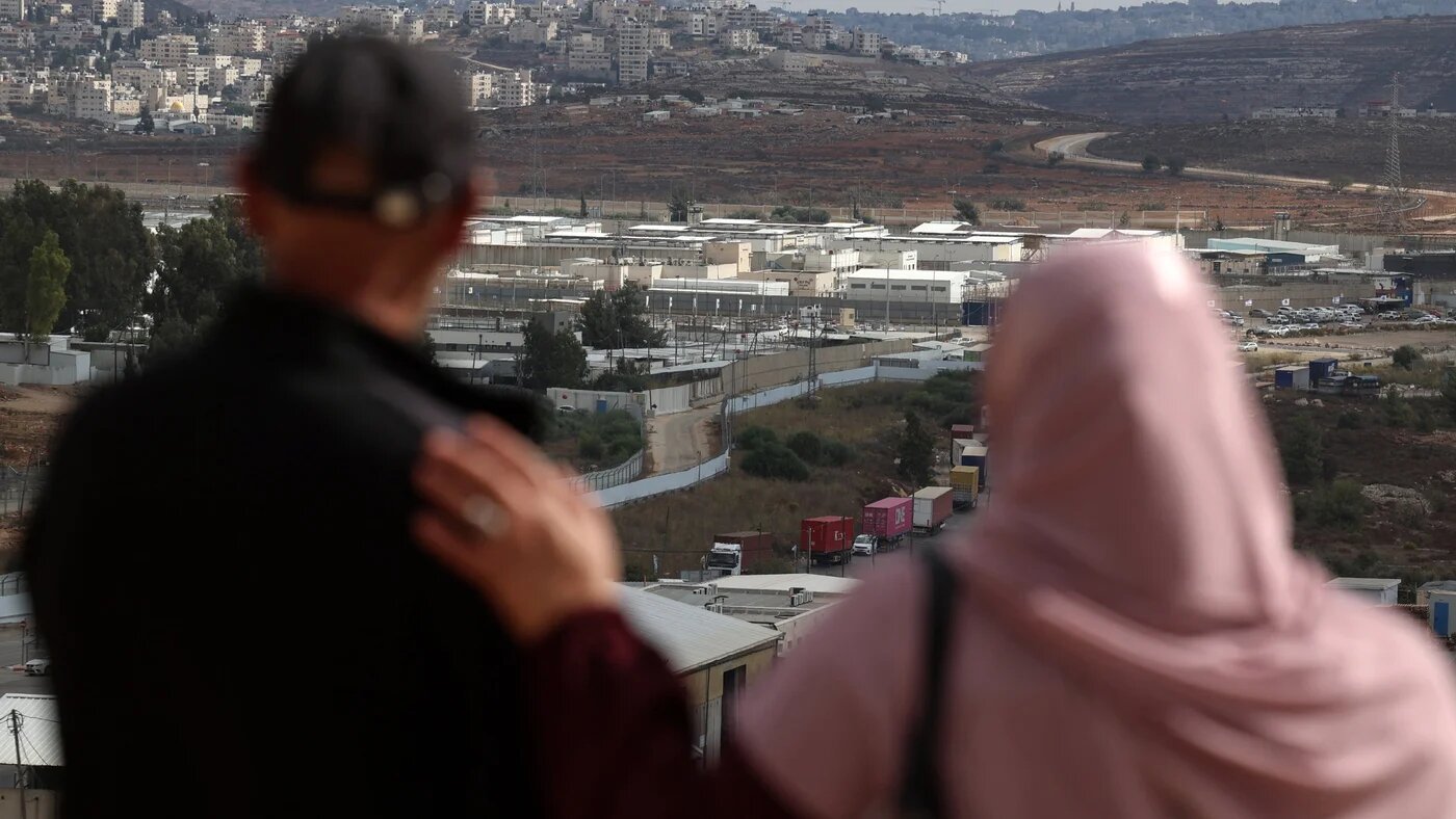 Relatives of a Palestinian prisoner look on at the Ofer military prison complex in the occupied West Bank on 12 October, 2025 (AFP/Zain Jaafar)