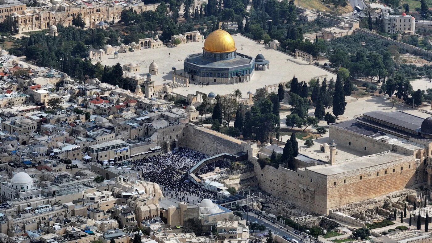 A drone view of Al-Aqsa Mosque as Jewish worshippers pray at the Western Wall in Jerusalem's Old City, 15 April (Reuters/Ilan Rosenberg)