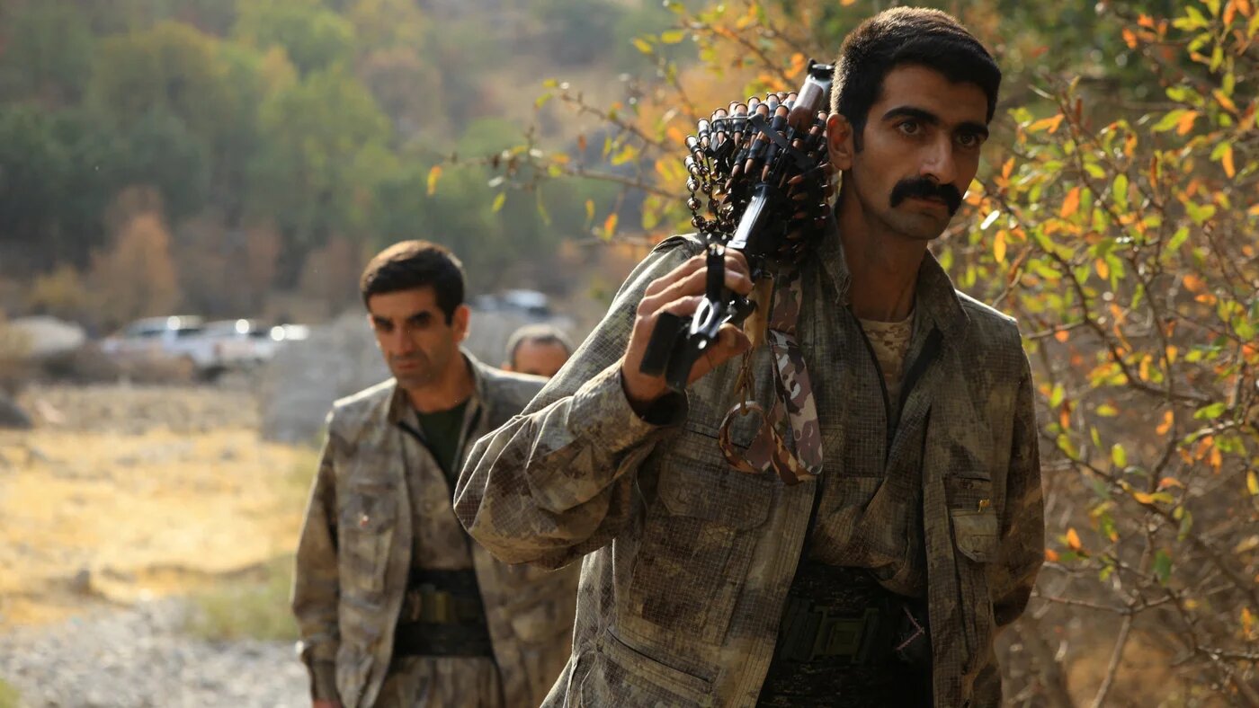 Fighters with the Kurdistan Workers' Party (PKK) walk for a disarmament ceremony in the Qandil mountains, Iraq, 26 October 2025 (Reuters)