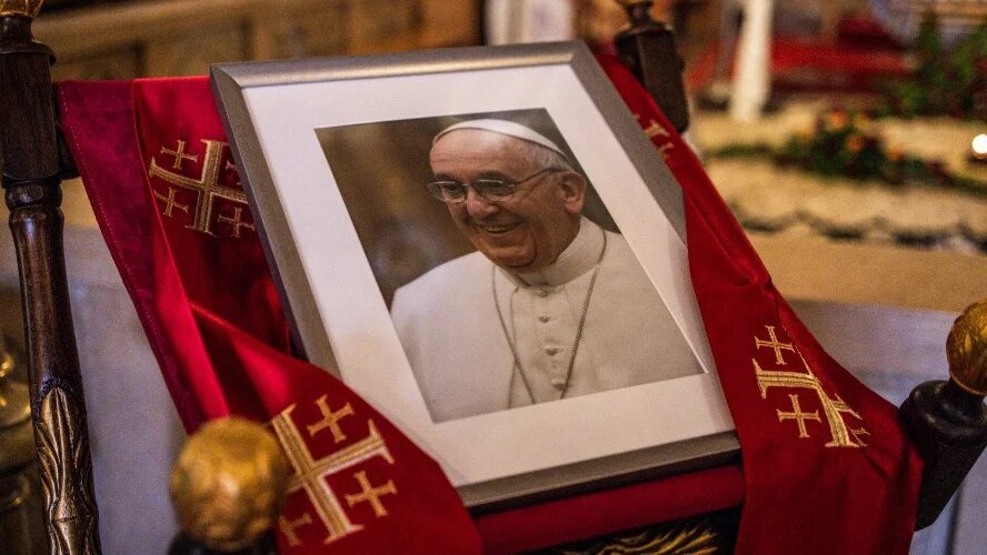 A portrait of Pope Francis is displayed in the Franciscan church in the Old City of Jerusalem on 21 April 2025 (John Wessels/AFP)