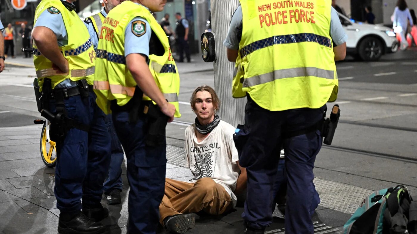 Police detain a man after scuffles during a pro-Palestinian demonstration against Israeli President Isaac Herzog's visit to Australia in Sydney on 9 February 2026 (AFP)