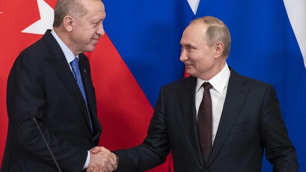 Turkish President Recep Tayyip Erdogan and Russian President Vladimir Putin shake hands in Moscow in March 2020 (AFP)