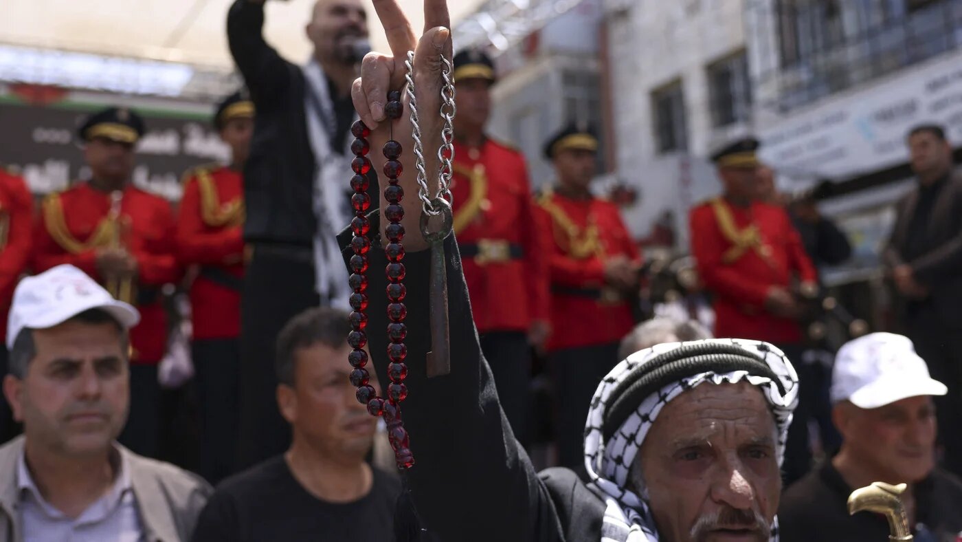 A protester holds a key symbolising the homes of Palestinians who were forcibly expelled in 1948 during a rally marking Nakba day in Ramallah, occupied West Bank, on 15 May, 2023 (AFP/Hazem Bader)