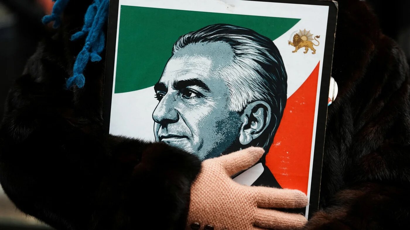 A protester holds an image of Reza Pahlavi during a demonstration against the Iranian government, in New York City, 15 March 2026 (Reuters/Adam Gray)