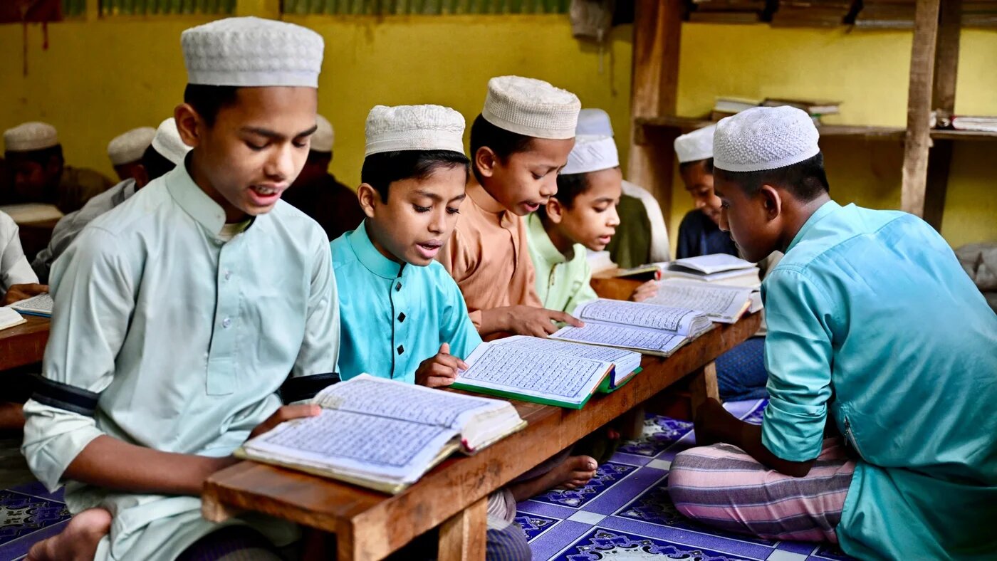 A group of Rohingya children can be seen reading the holy Quran in Balukhali camp in Ukhia, Bangladesh (Piyas Biswas/AFP)