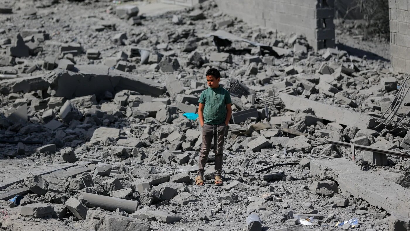A young boy stands amid the destruction following overnight US strikes in the Yemeni capital Sanaa on 27 April 2025 (AFP/Mohammed Huwais)