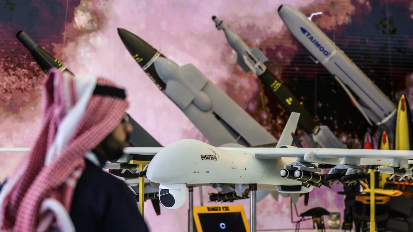 A man stands in front of the replica of a Shahpar-III combat drone during the World Defence Show in Riyadh on 9 February 2026 (Fayez Nureldine/AFP)