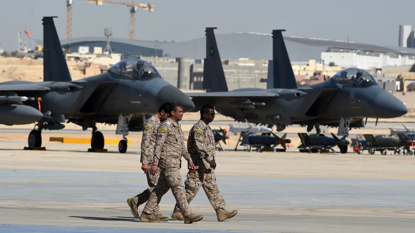 Saudi army officers walk past F-15 fighter jets, GBU bombs and missiles displayed during a ceremony marking the 50th anniversary of the creation of the King Faisal Air Academy at King Salman airbase in Riyadh on 25 January 2017 (AFP/Fayez Nureldine)