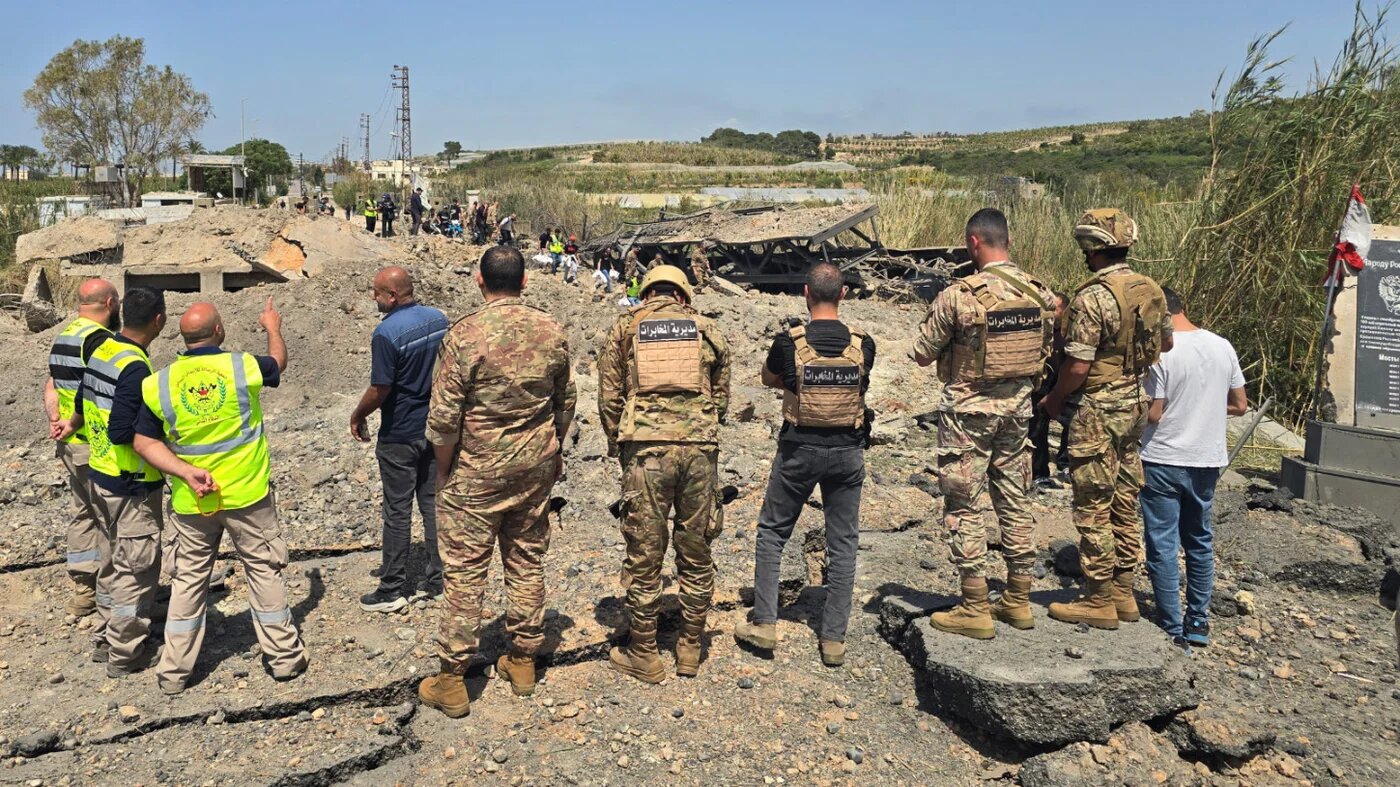 Lebanese army soldiers and first responders inspect the site of Israeli strikes that targeted the Qasmiyeh bridge built over the Litani River in the southern Lebanon on 16 April 2026 (Kawnat Haju/AFP)