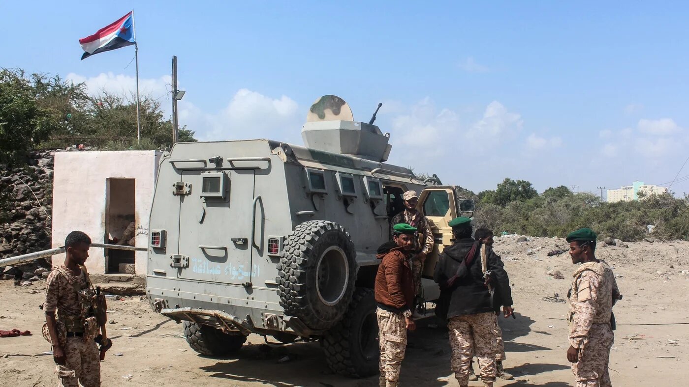 Members of the Southern Giants Brigades aka al-Amaliqa stand next to an armoured vehicle deployed in Aden on 7 January 2026 (AFP/Saleh al-Obeidi)