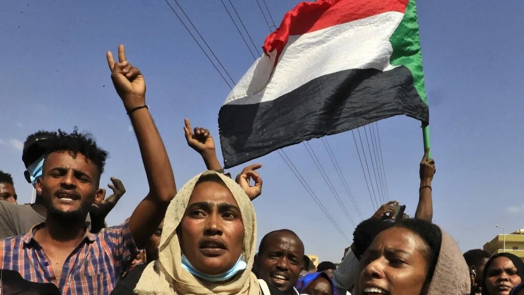 Sudanese protesters rally in Khartoum to denounce overnight detentions by the army of government members, on 25 October 2021.