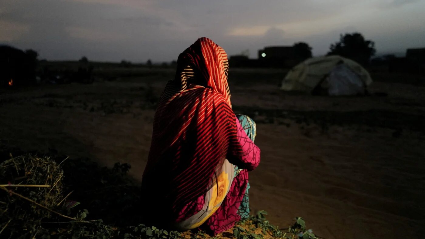 A 24-year-old mother, who said she was raped by militiamen in West Darfur, poses outside a makeshift shelter in Adre, Chad, 21 July, 2023 (Reuters/Zohra Bensemra)