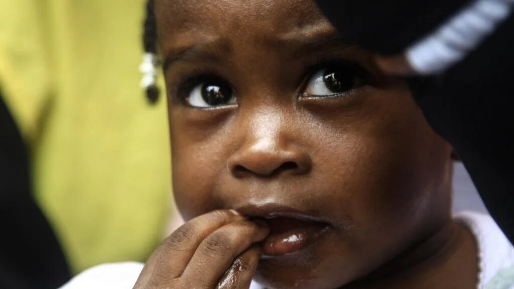 A Sudanese child waits her turn during an innoculation campaign in Gedaref state in eastern Sudan on 9 June 2024 (Ebrahim Hamid/AFP)