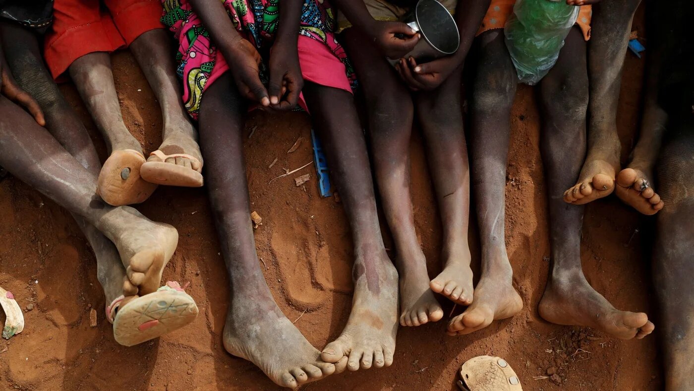In this file photo, Orphans and children separated from their parents in Kadugli gather to eat boiled leaves at an IDP Camp in Boram County, Nuba Mountains, South Kordofan, Sudan 22 June 2024 (Reuters/Thomas Mukoya)