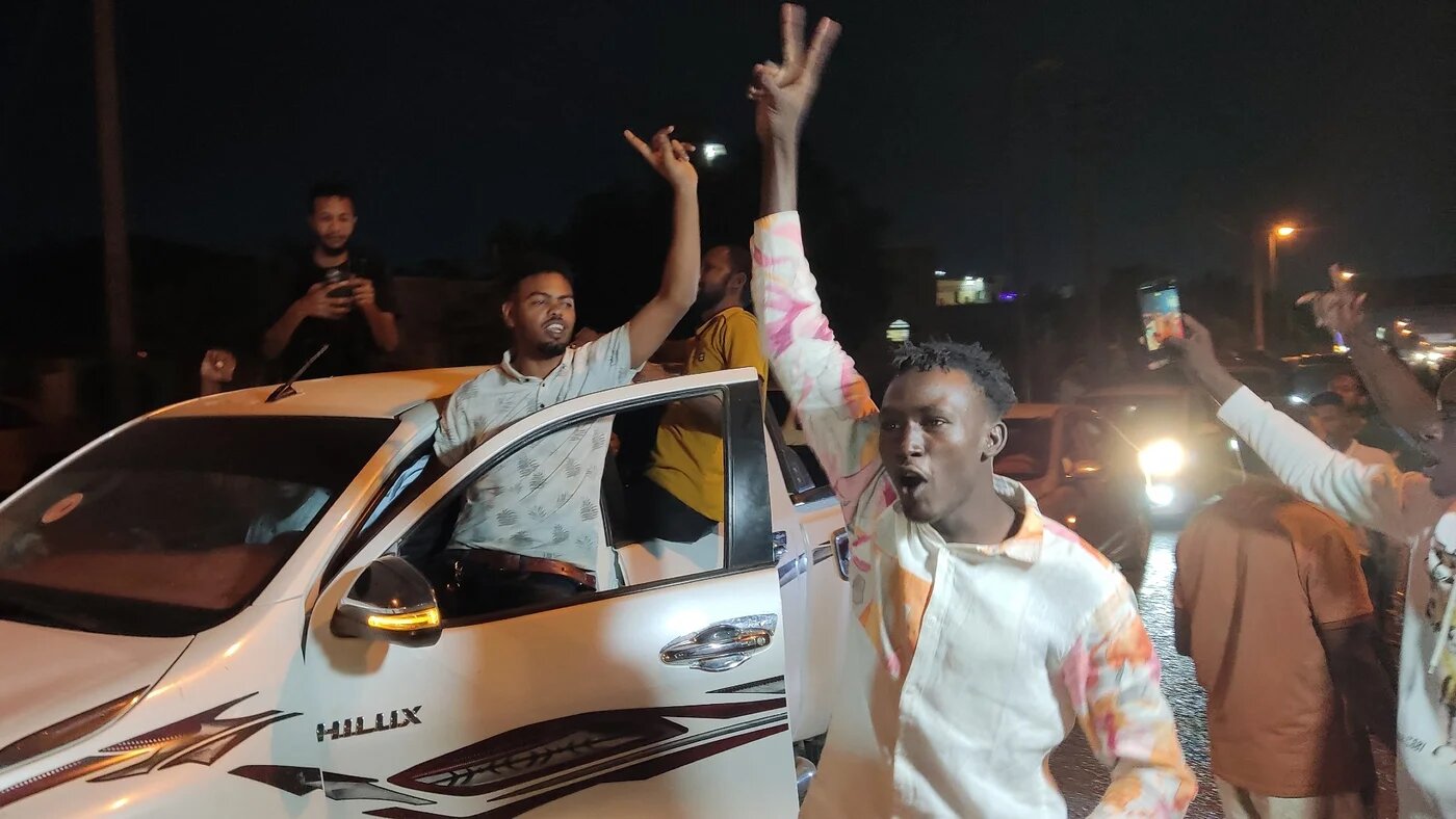 People take to the streets of Port Sudan to celebrate the taking the capital Khartoum by the army from the paramilitary Rapid Support Forces, on 26 March 2025 (AFP)