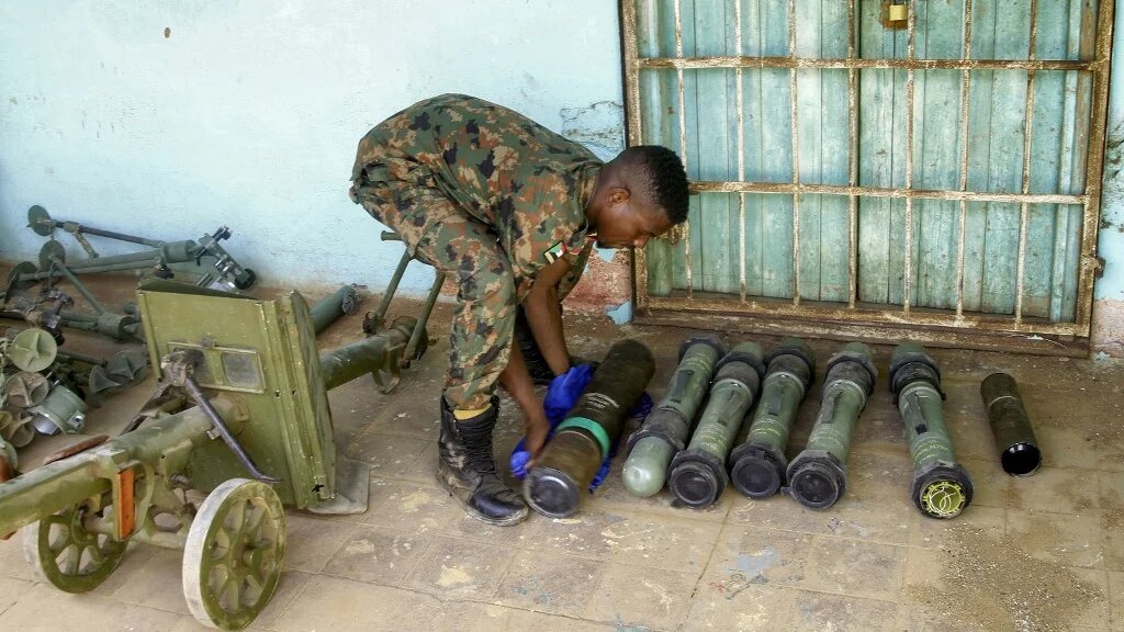 A Sudanese soldier carries anti-tank rockets seized from a base that had been used by the rival Rapid Support Forces, in the Salha area of Omdurman, on 26 May 2025 (Ebrahim Hamid/AFP)