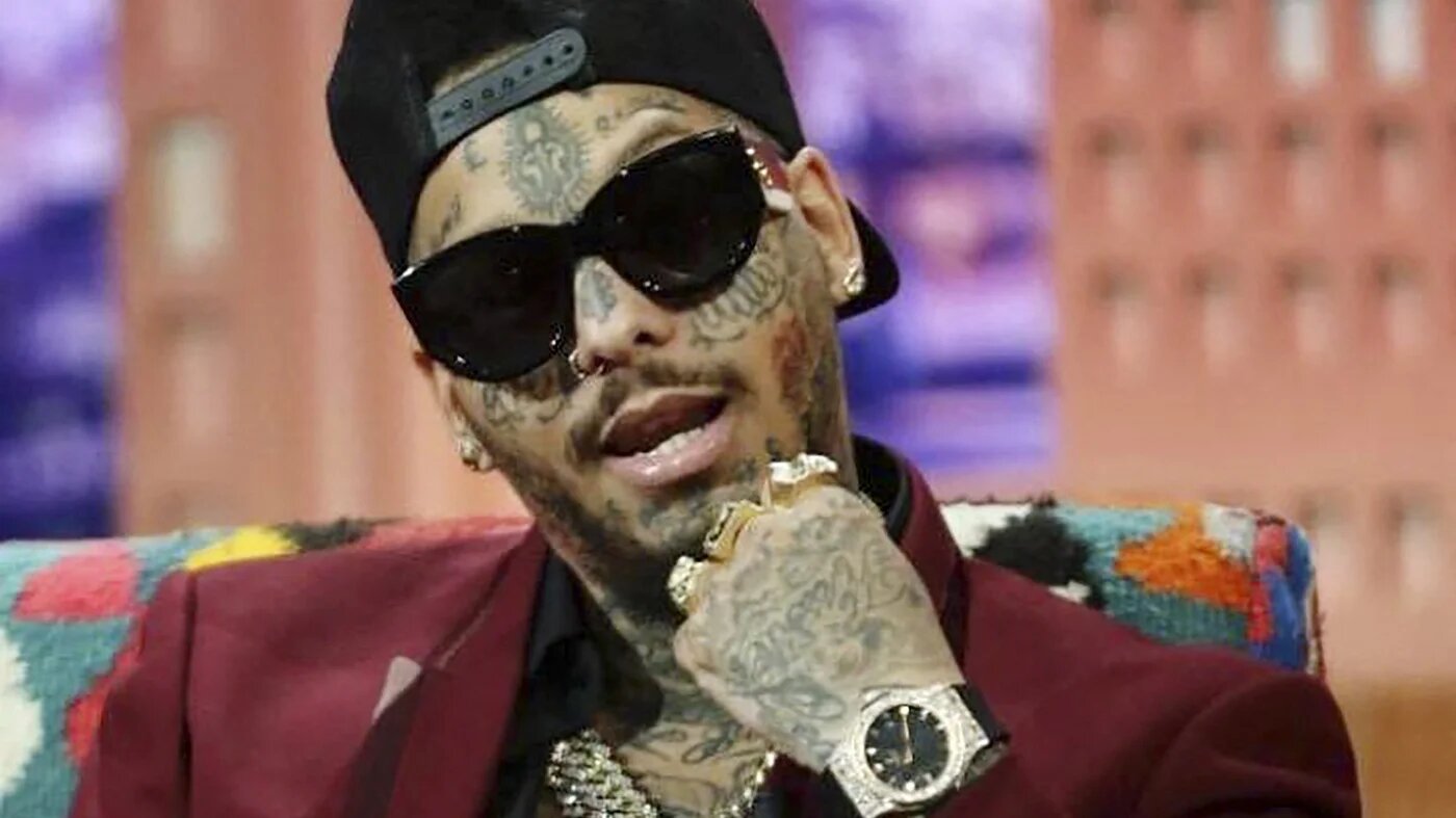 Tunisian-French rapper Swagg Man, who is known for Louis Vuitton logos tattooed on his bald head, during an interview with a television station in Tunis on 11 May, 2019 (AFP)