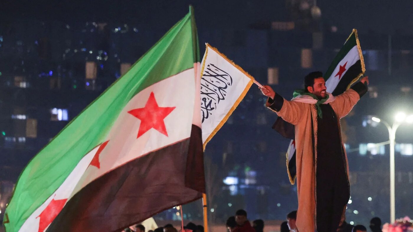 People celebrate after the Syrian Democratic Forces signed a deal agreeing to integrate into Syria's new state institutions, in Damascus, 11 March (Reuters/Khalil Ashawi)