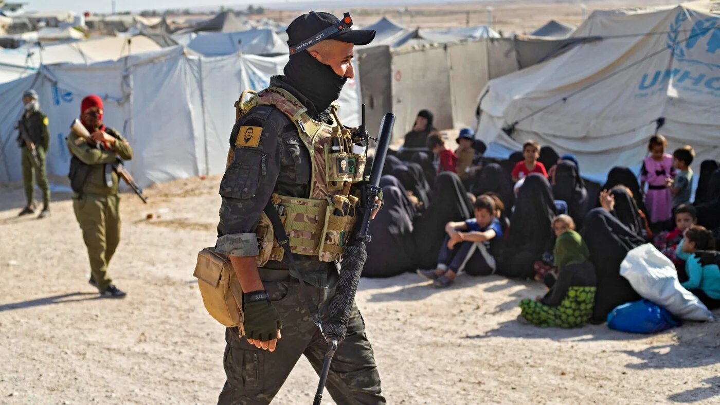 A Kurdish fighter patrols the al-Hol camp, which holds relatives of suspected Islamic State group fighters, in northeast Syria during a security operation on 26 August 2022.
