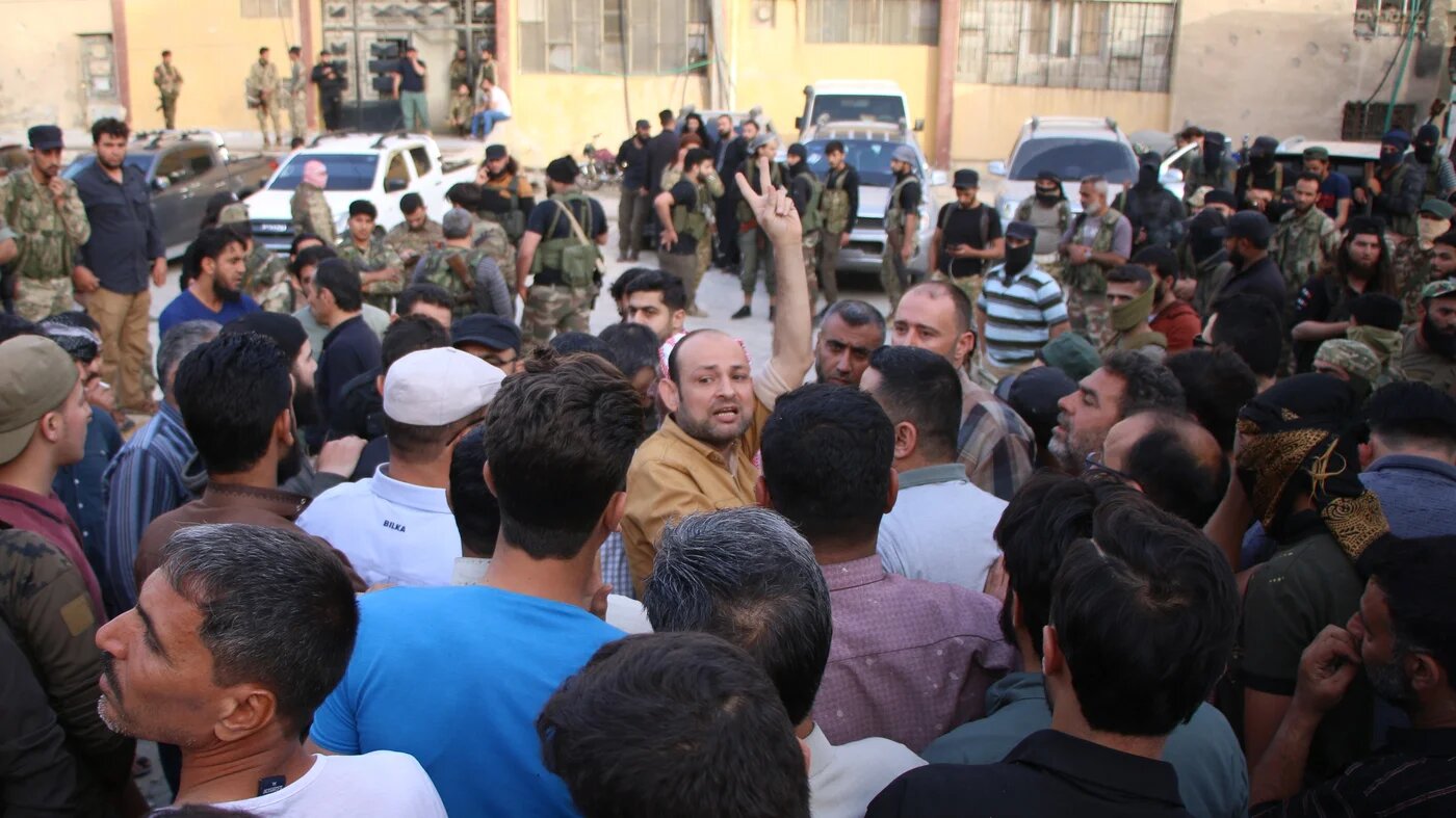 Protesters gather outside a military police station in al-Bab city in northwest Syria on 22 May 2022. (MEE/Walid al-ldlibi)