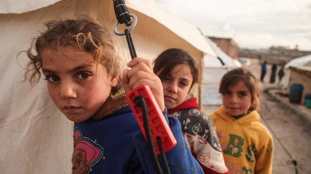 Displaced Syrian children are pictured at a camp near the Turkish border in December 2019 (AFP)