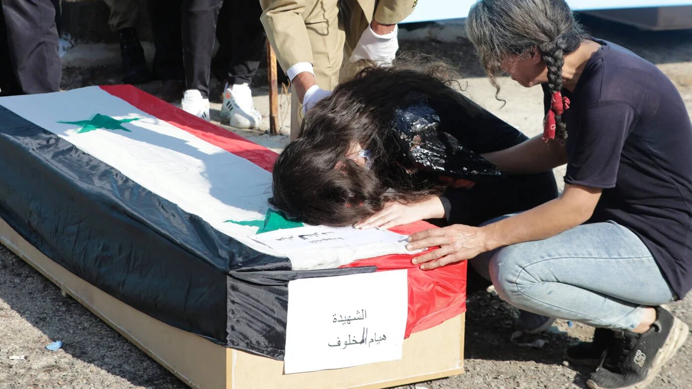 Relatives mourn at the funeral of the victims of a drone attack on a military academy in Homs, Syria, on 5 October 2023 (AFP)