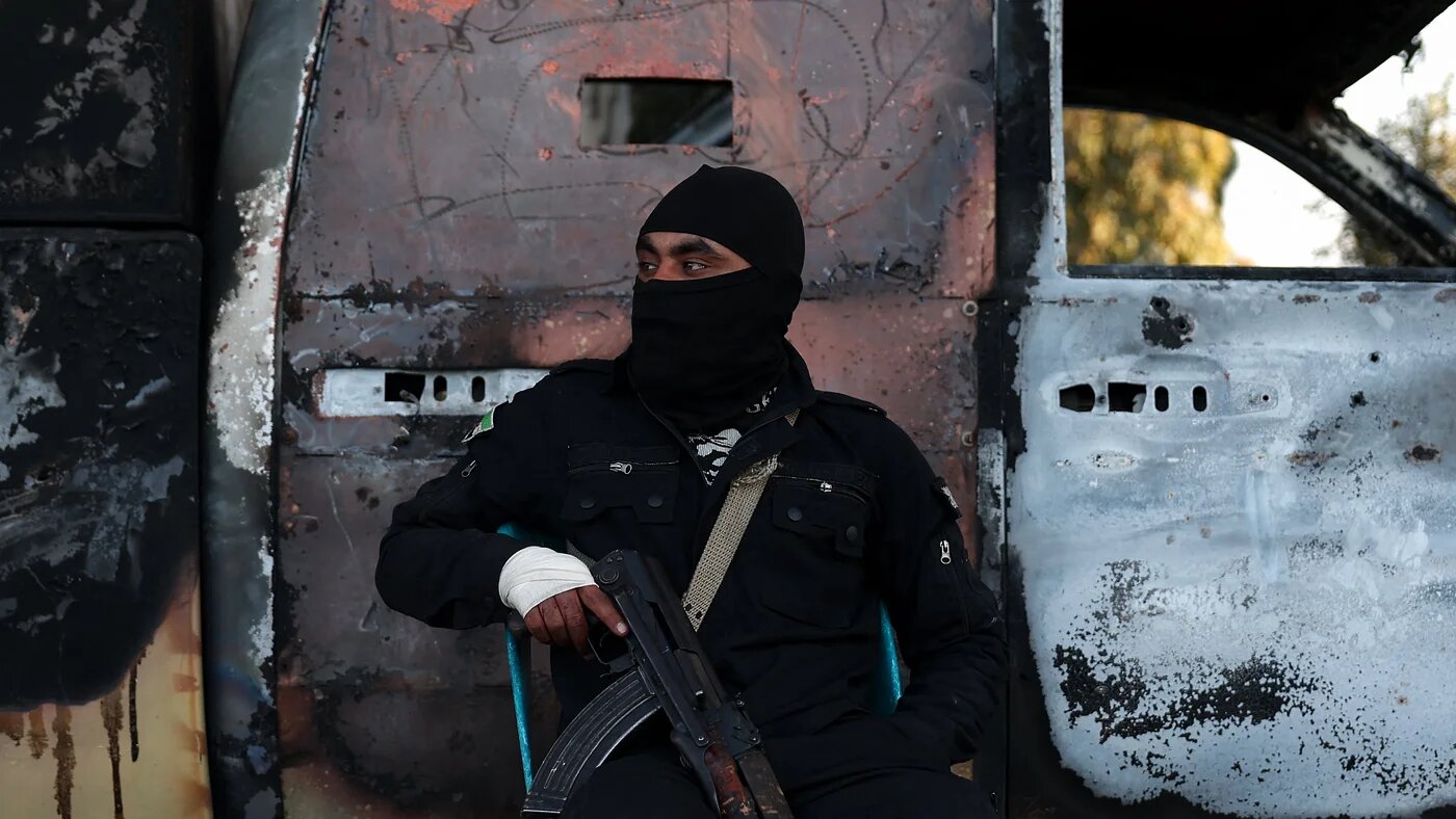 A member of the security forces loyal to the current Syrian government guards a checkpoint in the town of Hmeimim on 11 March 2025 (AFP/Omar Haj Kadour)