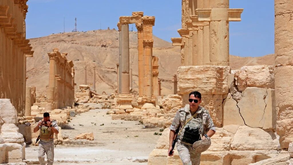Russian forces walk in the ancient Syrian city of Palmyra on 9 May, 2022 (AFP)