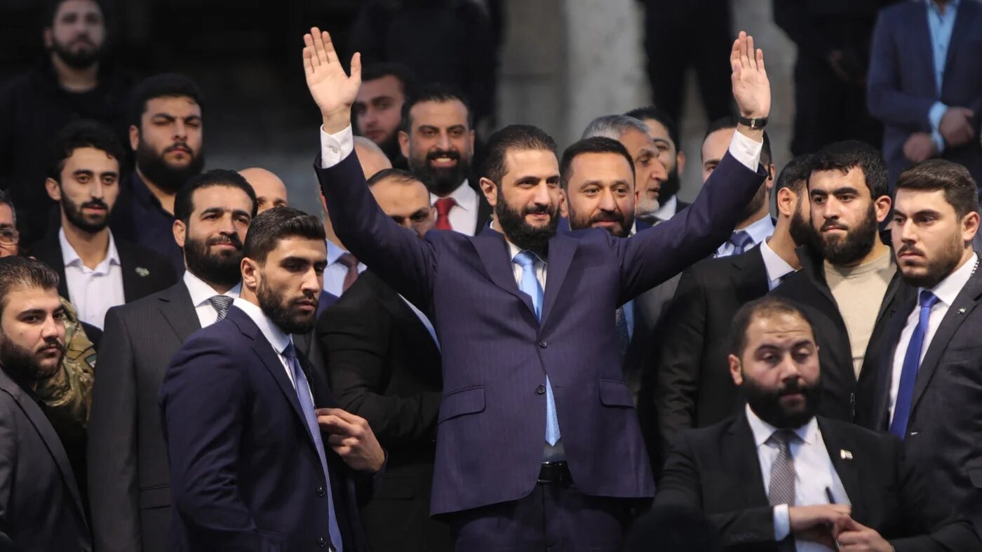 Syrian President Ahmed al-Sharaa waves to crowds at the gate of Aleppo’s Citadel on 29 November 2025 (Bakr Alkasem/AFP)