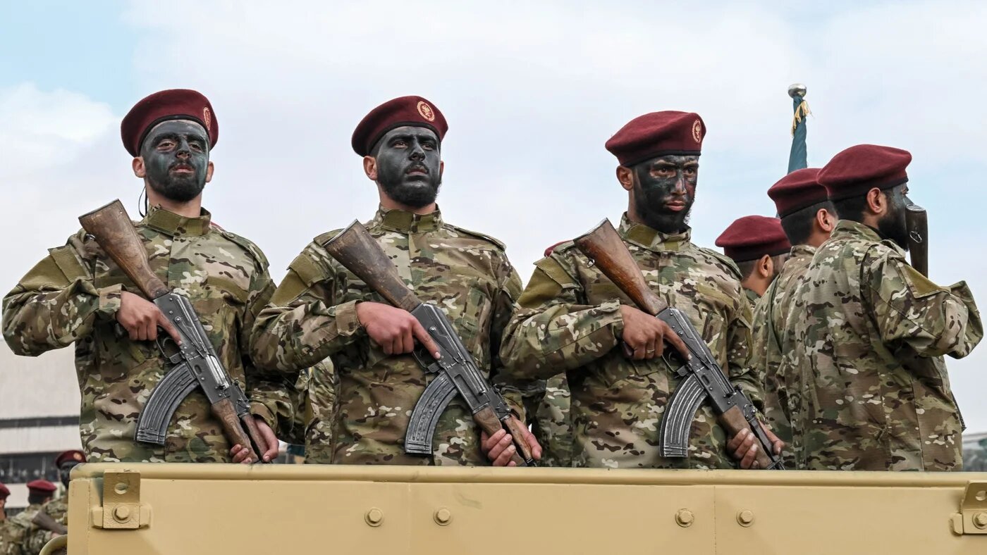 Military personnel during a parade as people gather to celebrate a year since the ousting of longtime ruler Bashar al-Assad in the Syrian capital Damascus on 8 December 2025 (AFP/Louai Beshara)