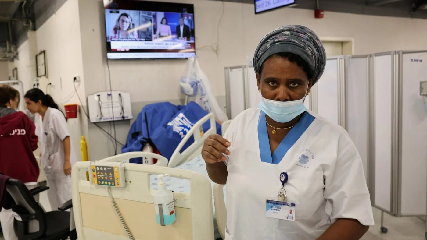 Workers at a hospital in Tel Aviv, 11 December (Reuters)