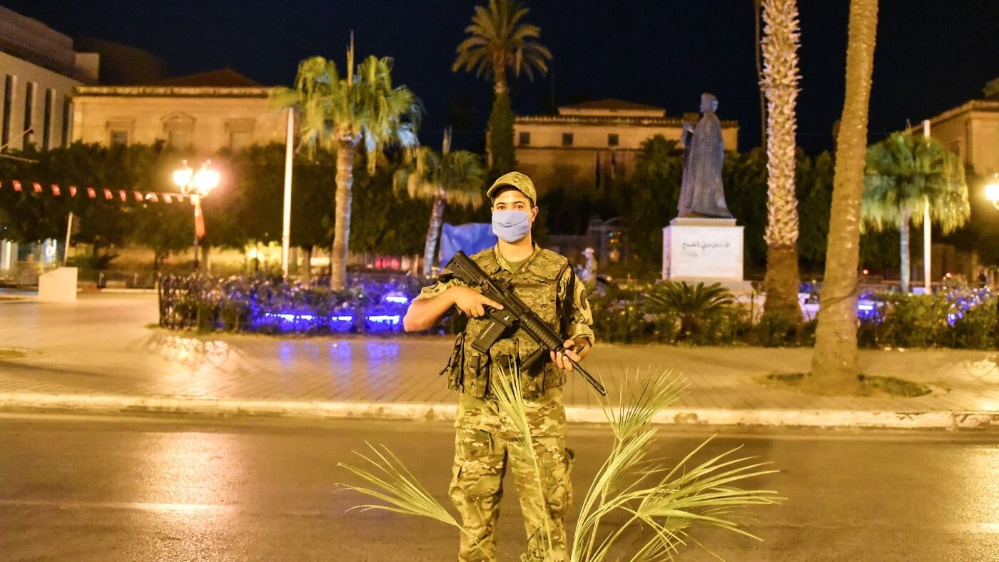 A Tunisian army officer stands guard in the capital Tunis after President Kais Saied announced the suspension of the country's parliament and the dismissal of Prime Minister Hichem Mechichi on 26 July 2021 (ZUMA Press Wire via Reuters)