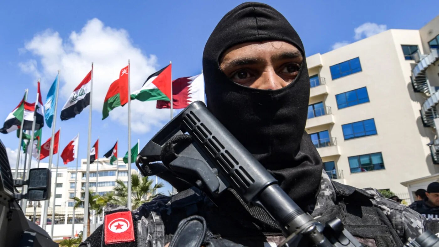 Tunisian security forces stand guard outside the AIMC HQ in Tunis, Tunisia in March 2019 (AFP)