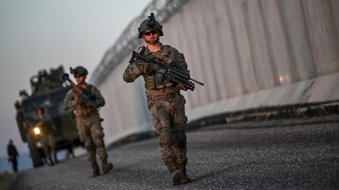Turkish soldiers patrol near the border wall between Turkey and Iran in the Van Province, eastern Turkey, on 1 November 2024 (Ozan Kose/AFP)