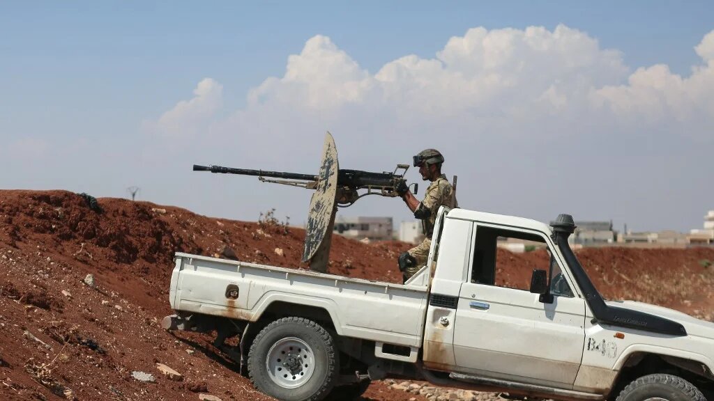 A Turkey-backed Syrian fighter mans a position in the northern Aleppo countryside on 20 August 2022 (AFP)