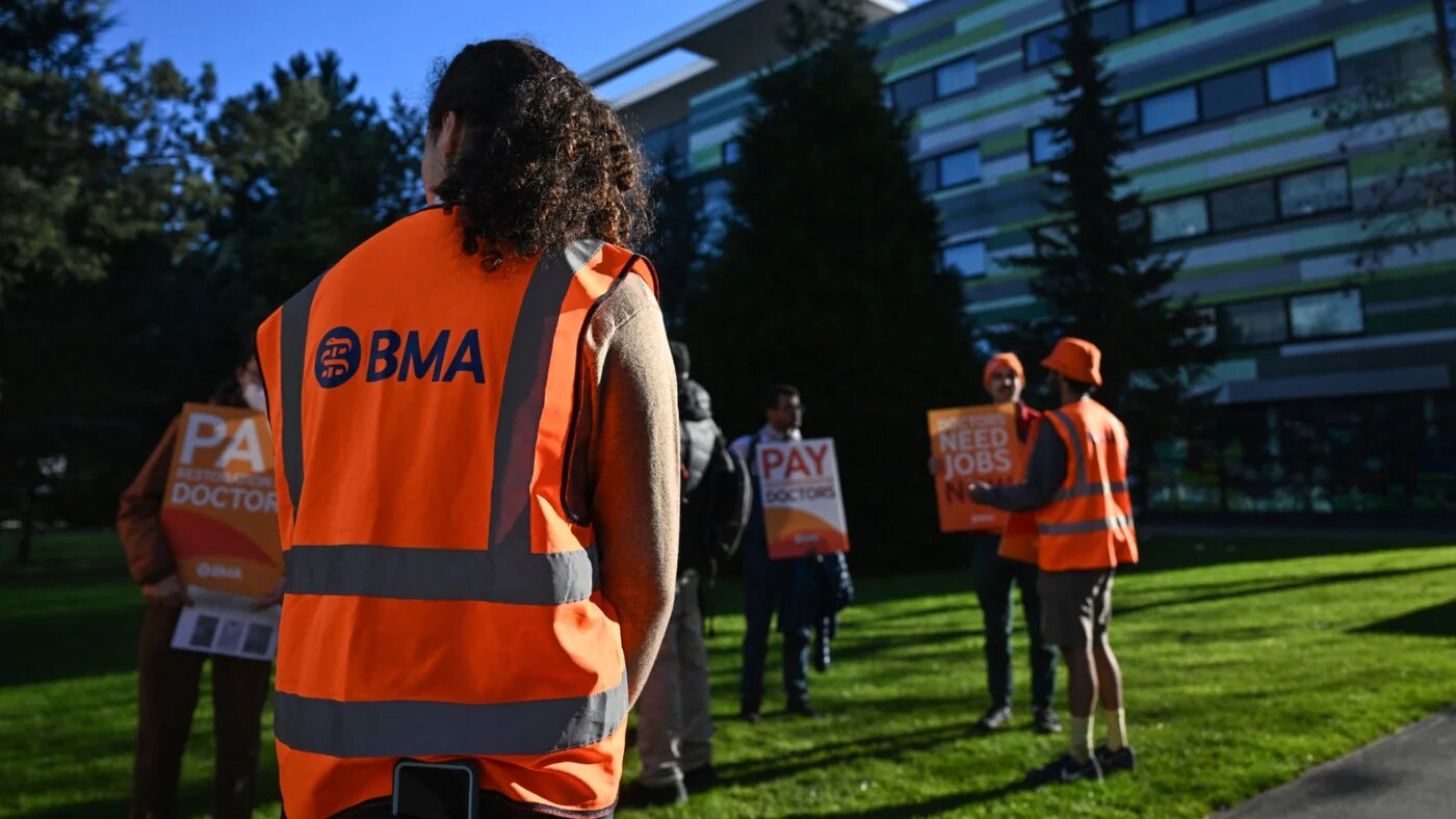 A member (front L) of the British Medical Association (BMA) joins staff (behind) as they gather during the first day of a six-day resident doctors' strike outside the Manchester University NHS Foundation Trust in Manchester, northwest England on 7 April 2026 (AFP)