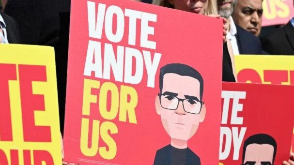 Supporters hold placards promoting Andy Burnham in the Makerfield by-election campaign, in northwestern England on 22 May 2026 (Paul Ellis/AFP)