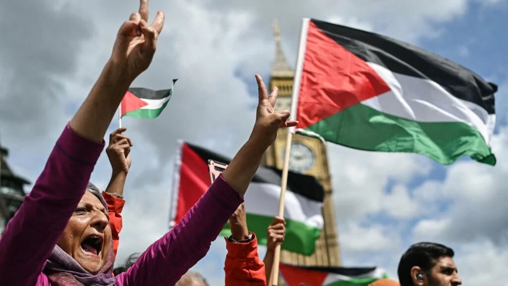 Protesters chant slogans and wave Palestinian flags during a demonstration against Israel’s genocide in Gaza, in central London on 8 June 2024 (Justin Tallis/AFP)