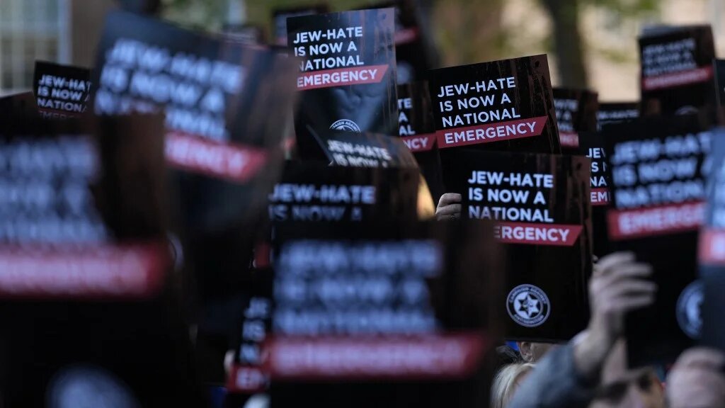People hold banners at a rally organised by the Campaign Against Antisemitism after the Golders Green stabbings, in London on 30 April 2026 (Carlos Jasso/AFP)